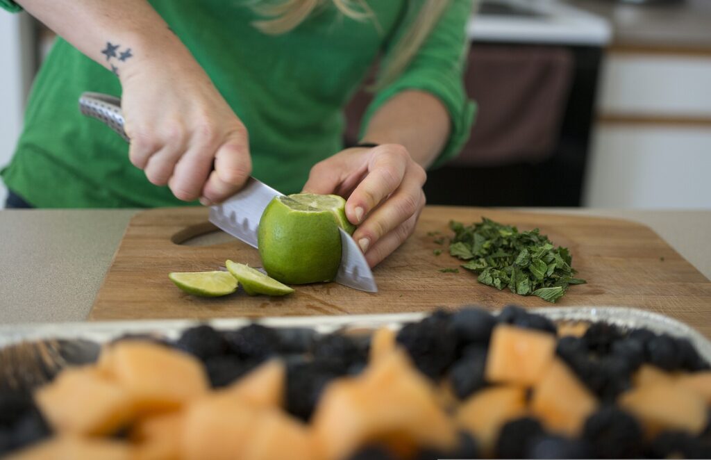 U.S. Air Force Senior Airman Megan Stanton, a medic with the 366th Medical Operations Squadron, slices a lime for fruit salad at her home in Mountain Home, Idaho, July 17, 2013 130717-F-NW635-041