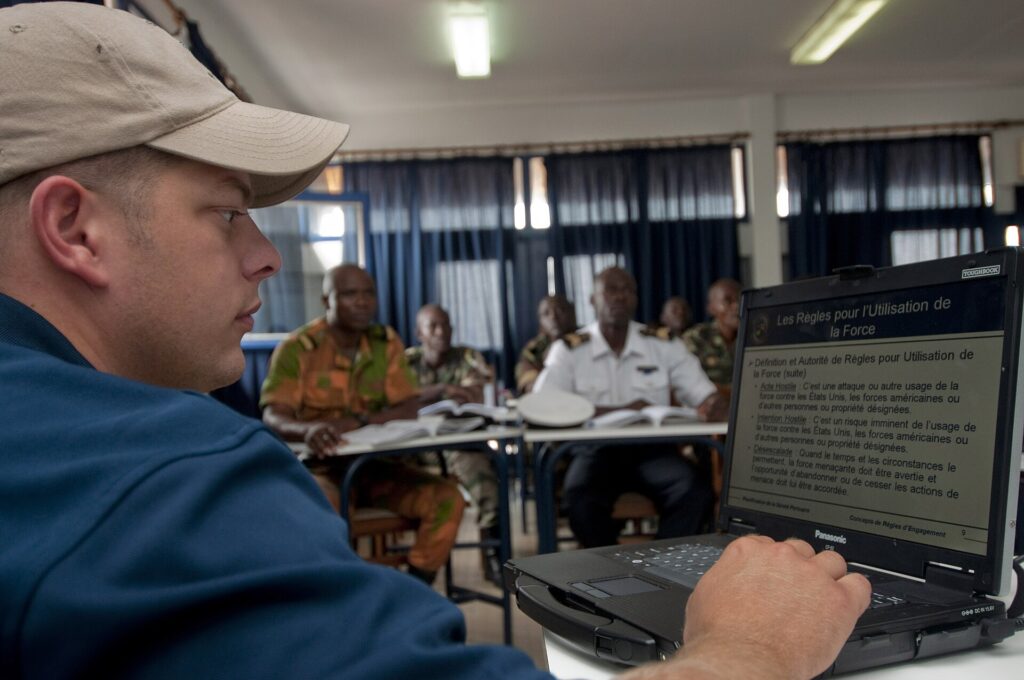 US Navy 100720-N-9589S-432 Master-at-Arms 2nd Class John Curry of Maritime Civil Affairs Security Training, Security Forces Assistance team, guides members of the Cameroon navy through a French version of an electronic presenta